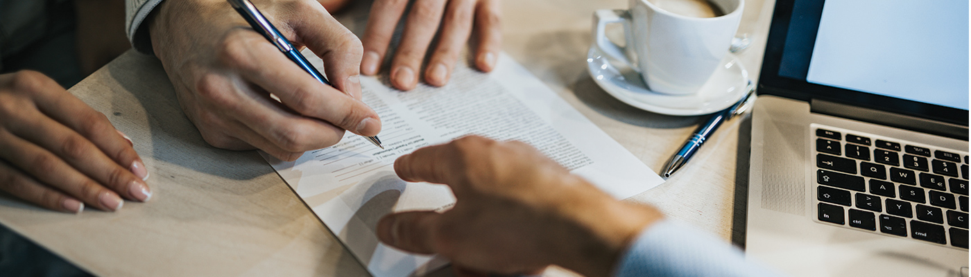 Close-up shot of business plans in coffee shop setting